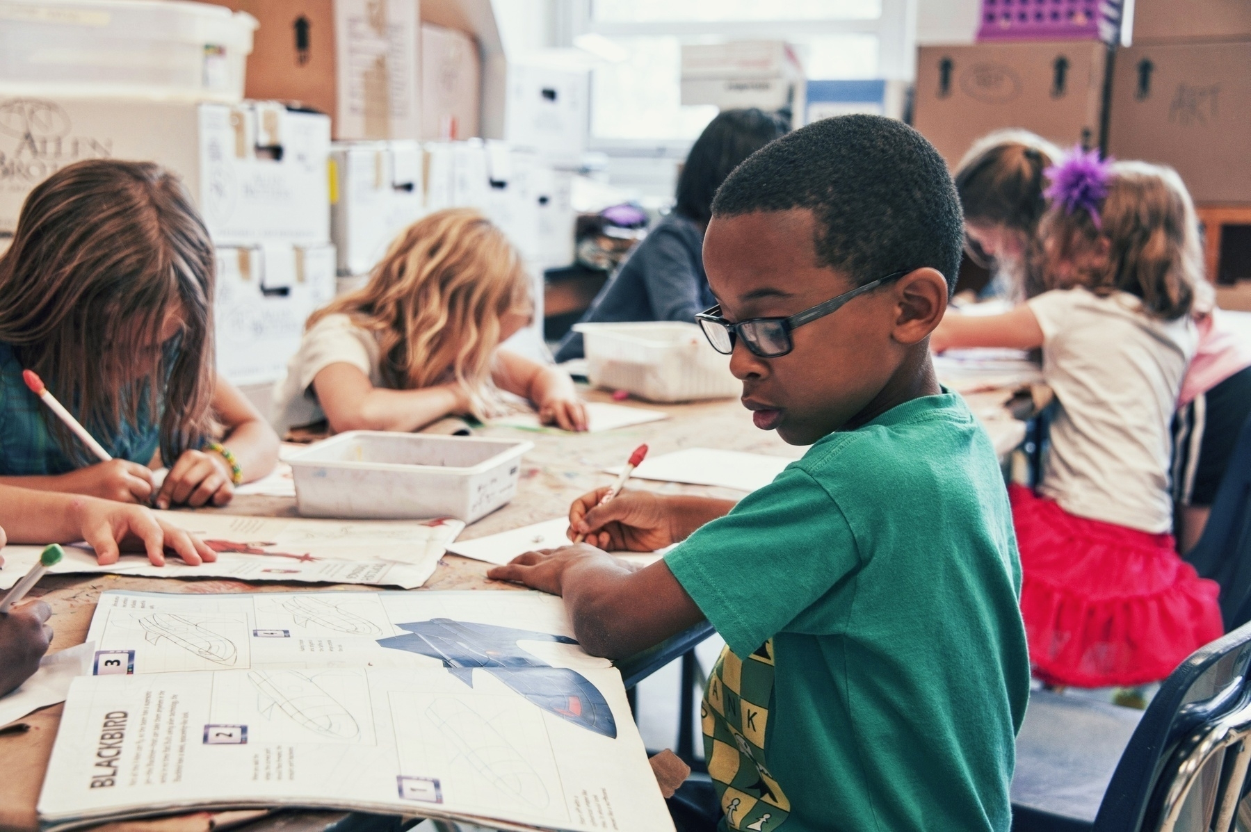 Children in a classroom doing work at their desks