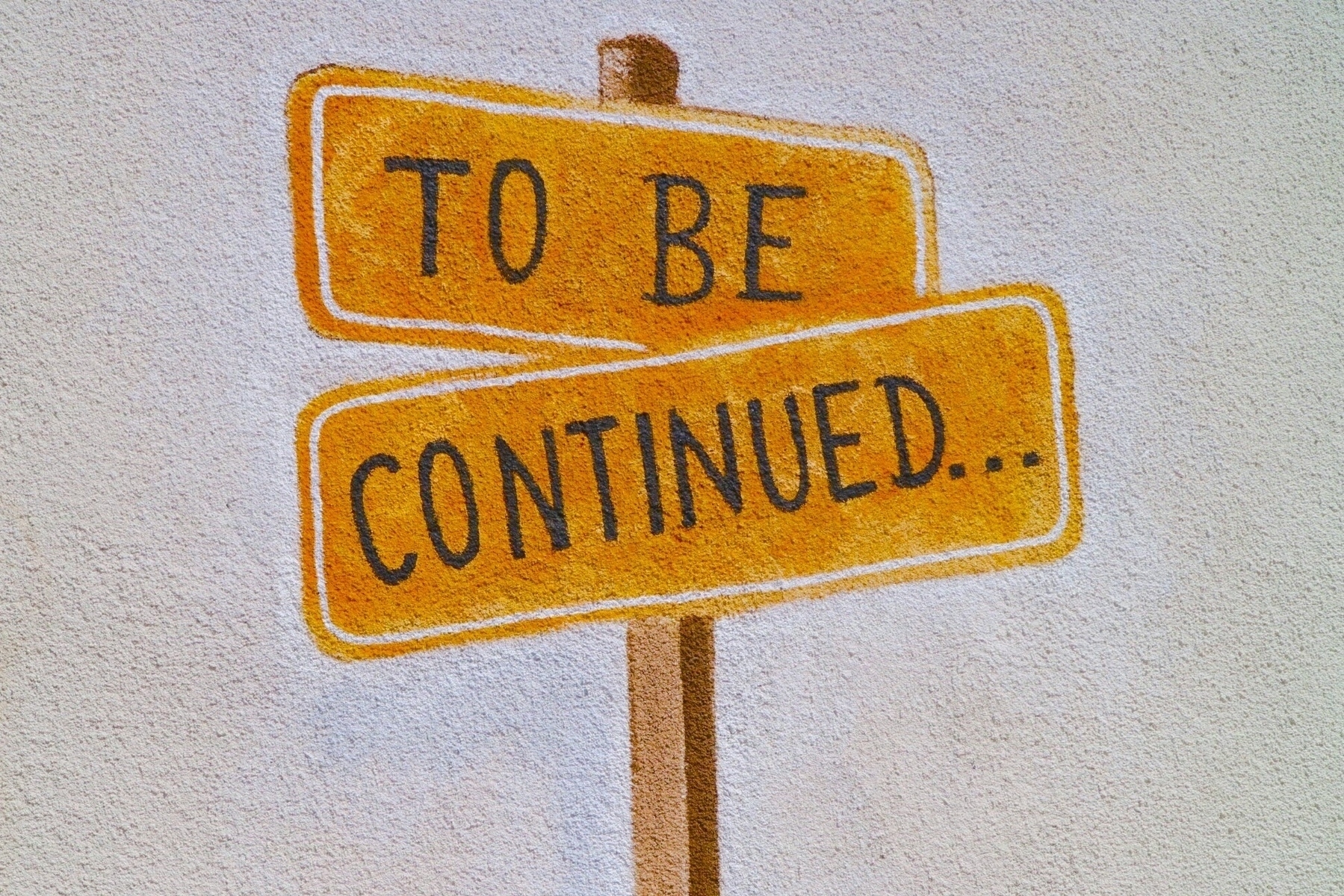road sign painted on a wall saying to be continued